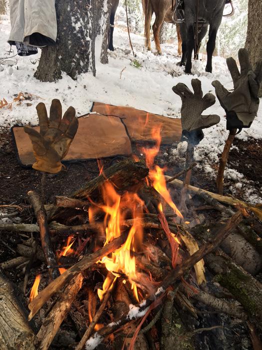 Drying gloves by a fire