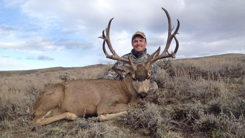 Brady with an idaho mule deer buck taken with whiskey mountain outfitters