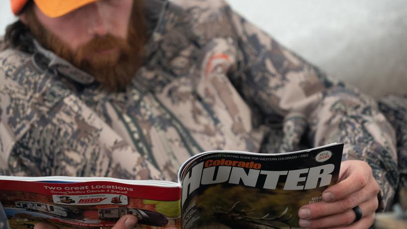 Brady reading Colorado Hunter Magazine at Camp.jpeg