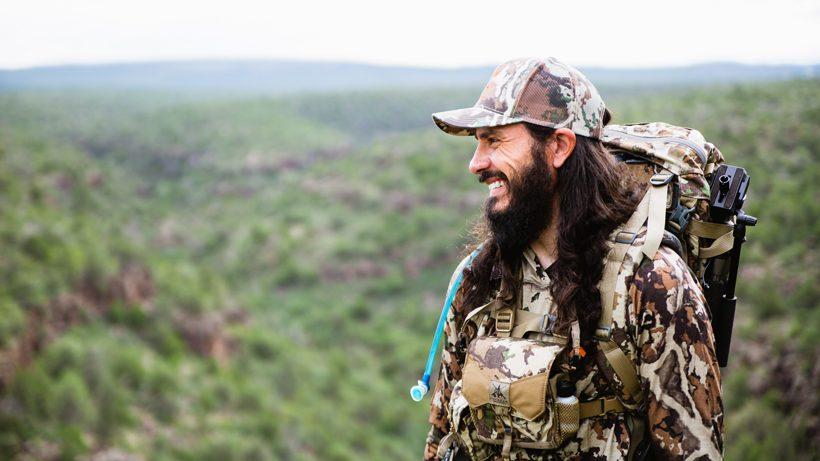 Hunter smiling while standing in front of a lush green valley in arizona