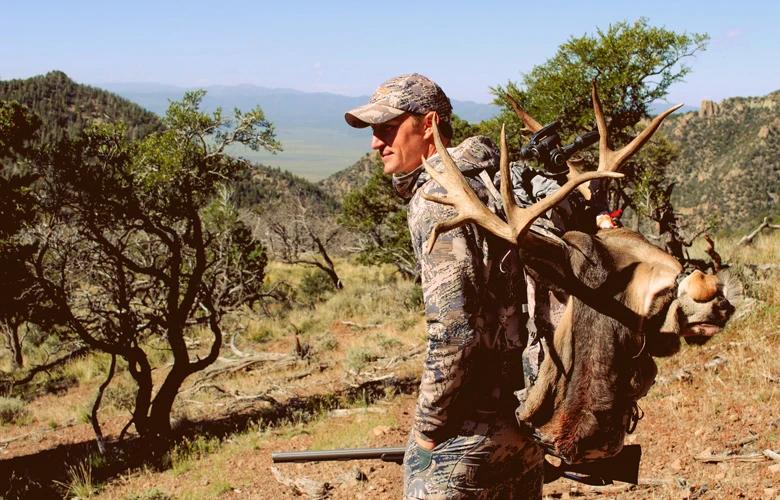 Trail kreitzer packing out a mule deer 1