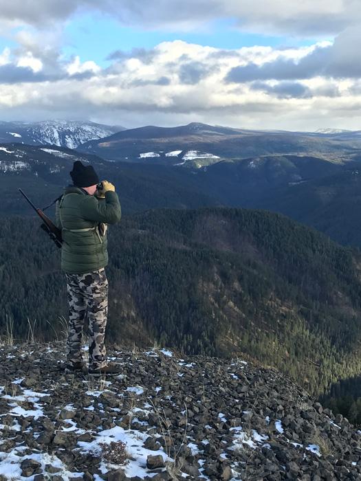 Hunter glassing on top of a rocky hill