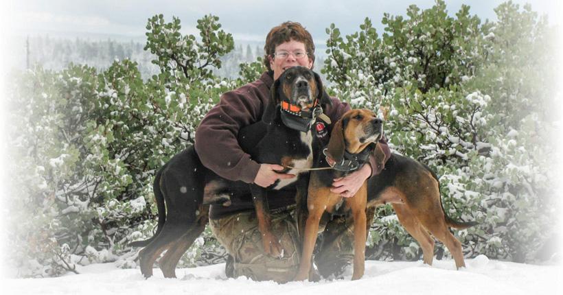 Lori jacobs with two bear hunting hounds