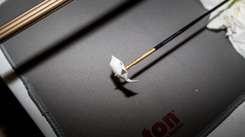 Placing rifle bore cleaning patch on jag