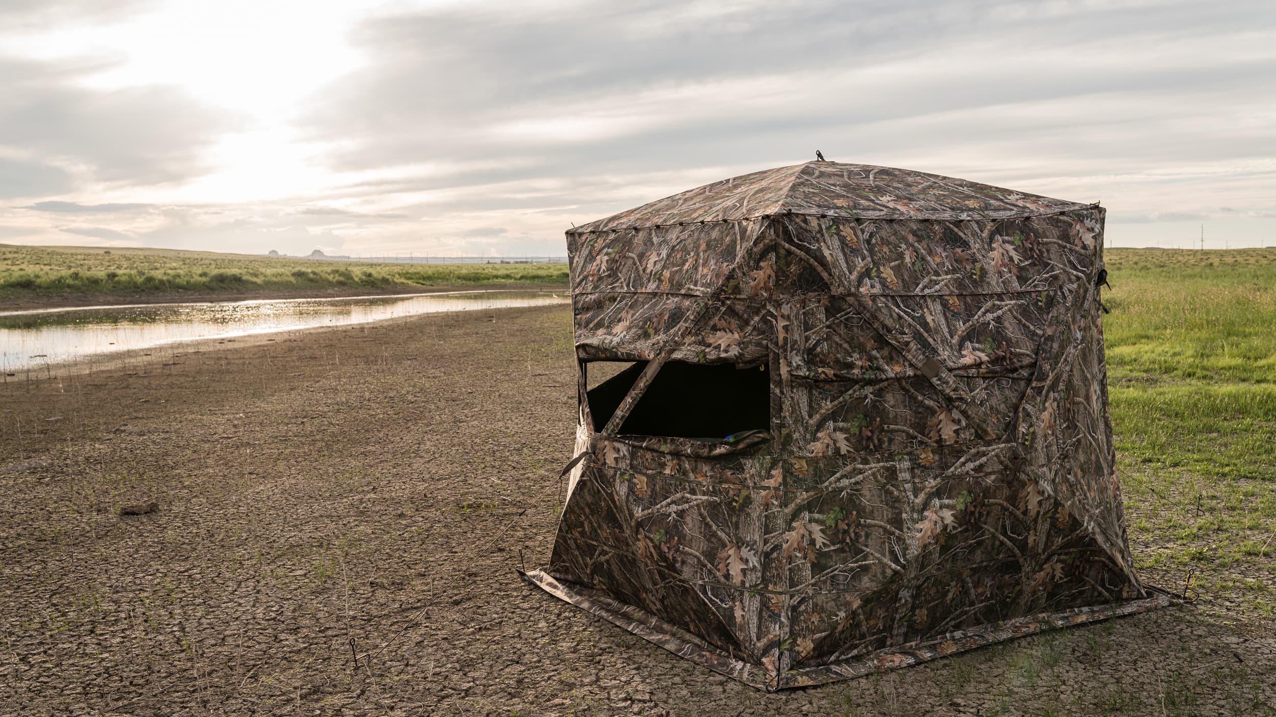 Window openings for bowhunting antelope from a ground blind