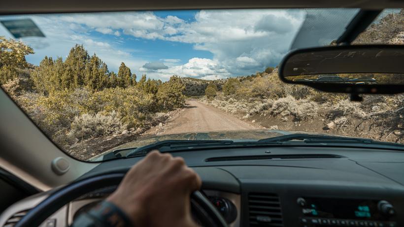 Driving down roads to summer scout for mule deer