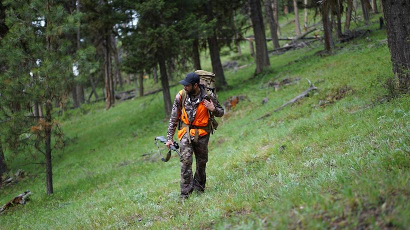 Remi warren hiking through the green on bear hunt