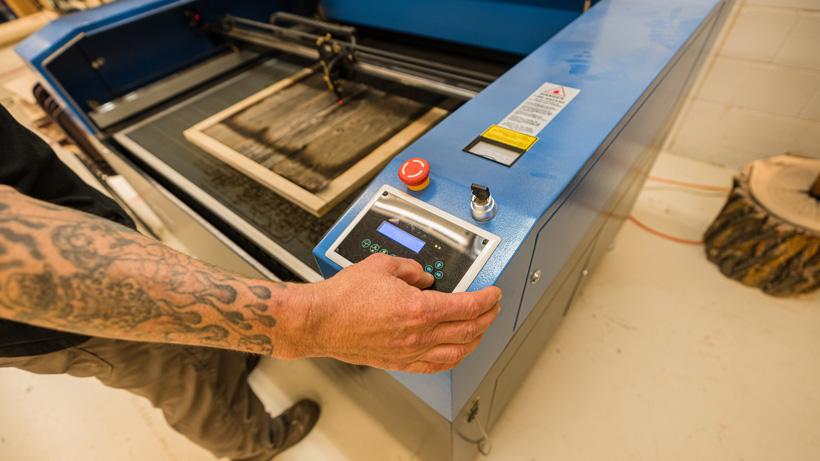 Laser engraving gohunt logo to pedestal