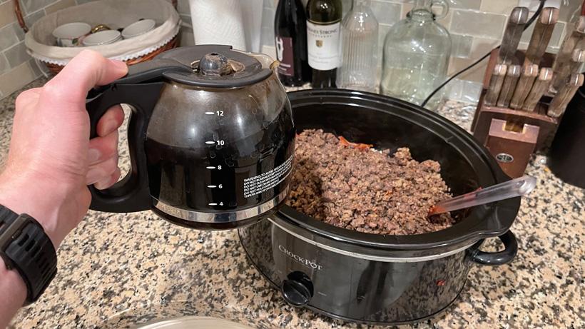 Adding black coffee to mule deer chili