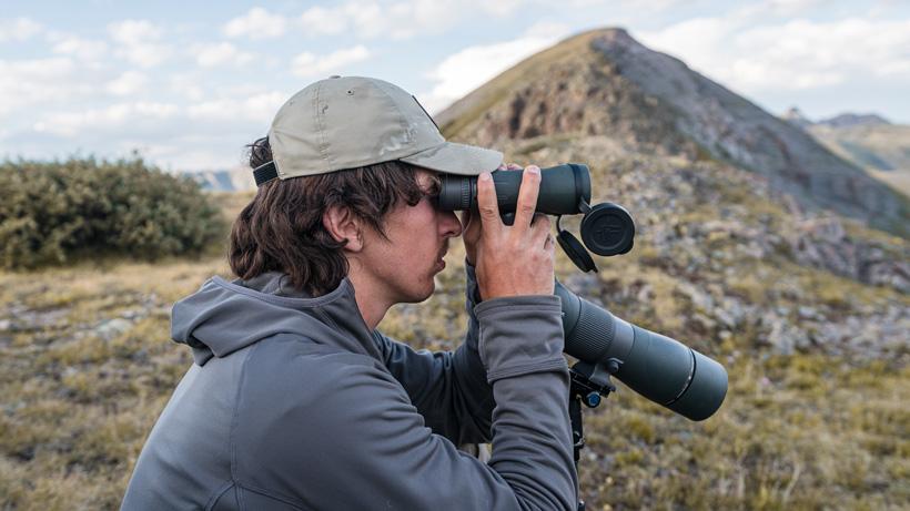 Using spotting scope to stabilize binoculars
