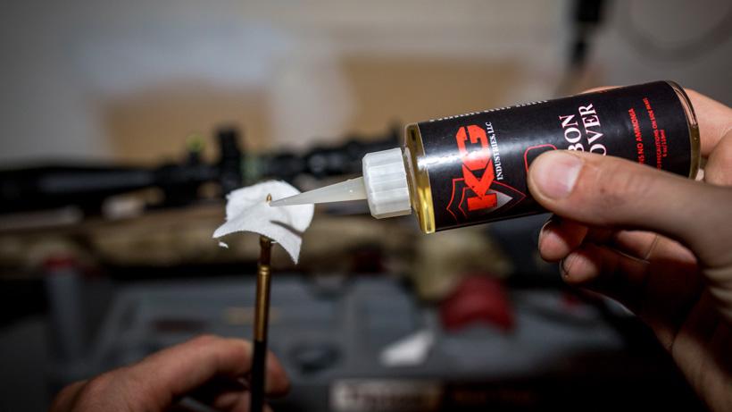 Applying carbon remover to rifle bore cleaning patch
