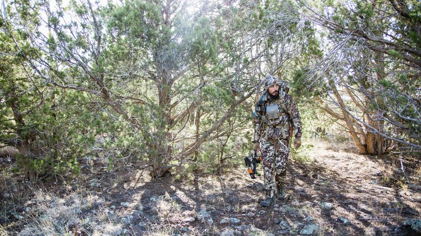 Josh kirchner hiking with bow in first lite clothing