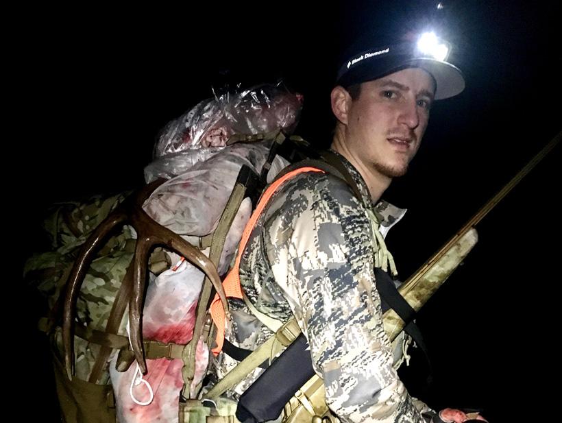 Dave Barnett packing out a mule deer buck