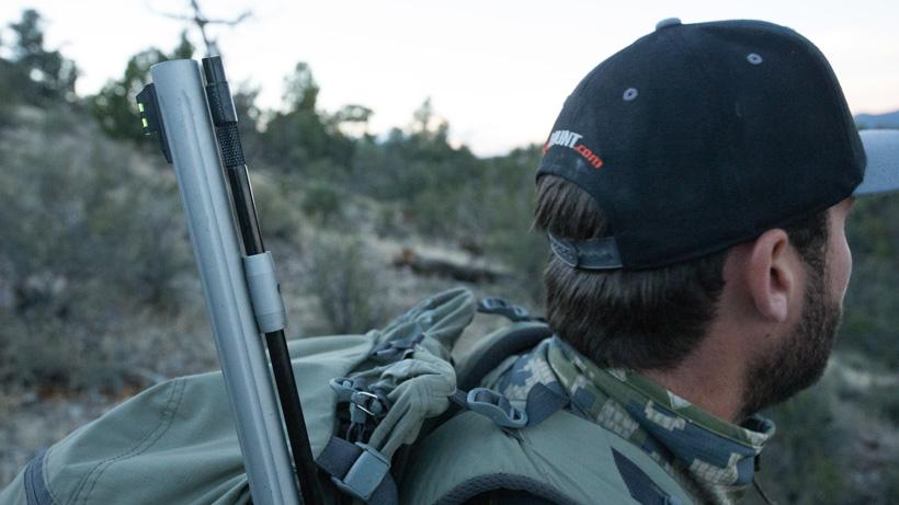 Hunter carrying a muzzleloader on a Western mule deer hunt