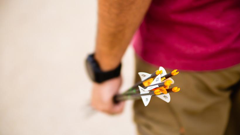 Hunter holding handful of arrows