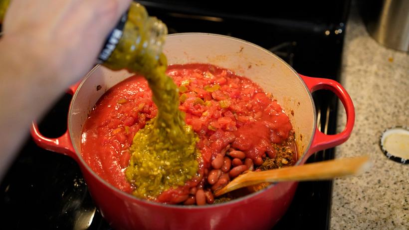 Adding green chile salsa